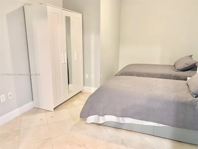 a bedroom with a bed and a cabinets