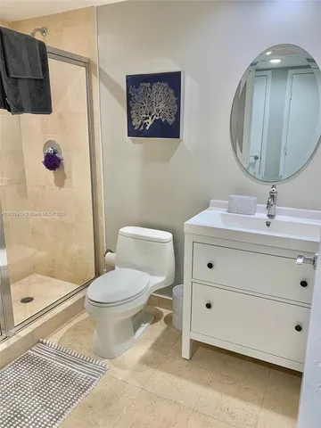 a bathroom with a toilet sink and a mirror