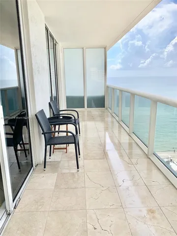 a view of a hallway with furniture and a rug