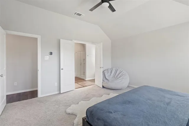 a bedroom with a bed and chair