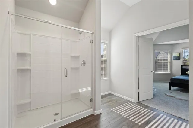 a bathroom with a glass shower door