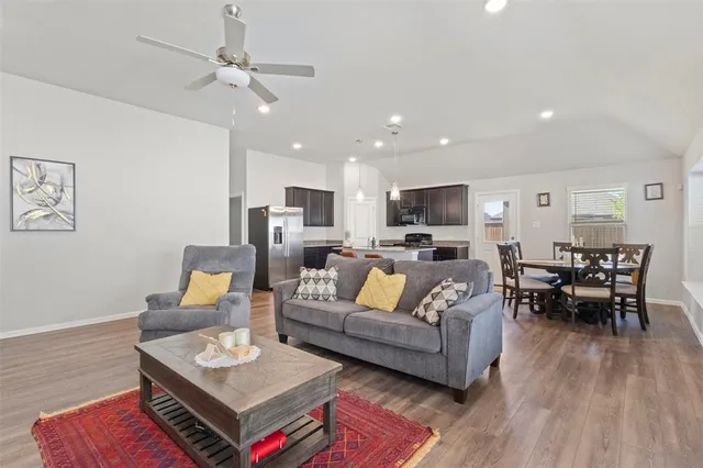 a living room with furniture and wooden floor
