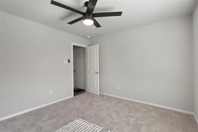 an empty room with a ceiling fan and a ceiling fan