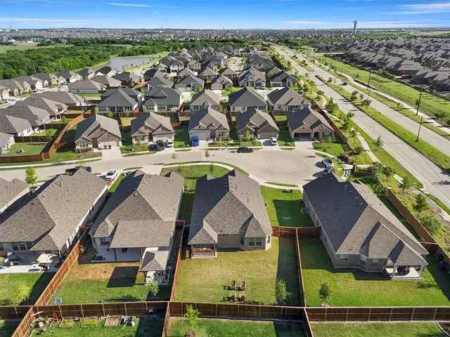 an aerial view of residential houses with outdoor space and swimming pool