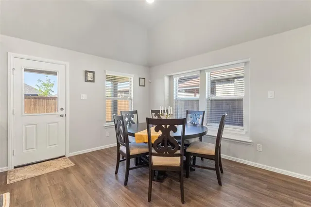 a view of a dining room with furniture and wooden floor