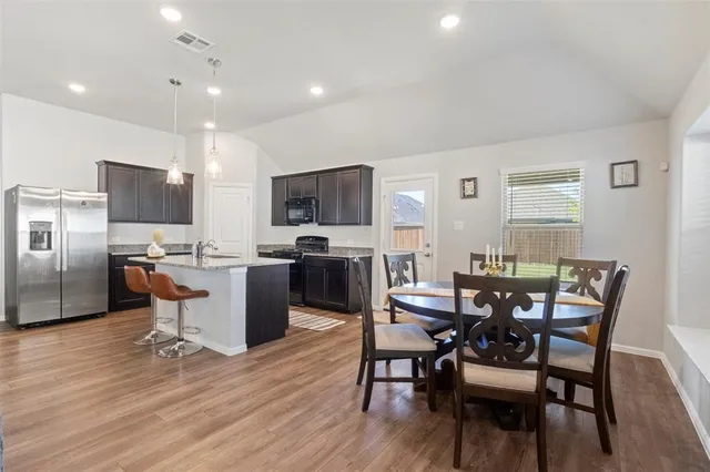 a view of a dining room with furniture and wooden floor