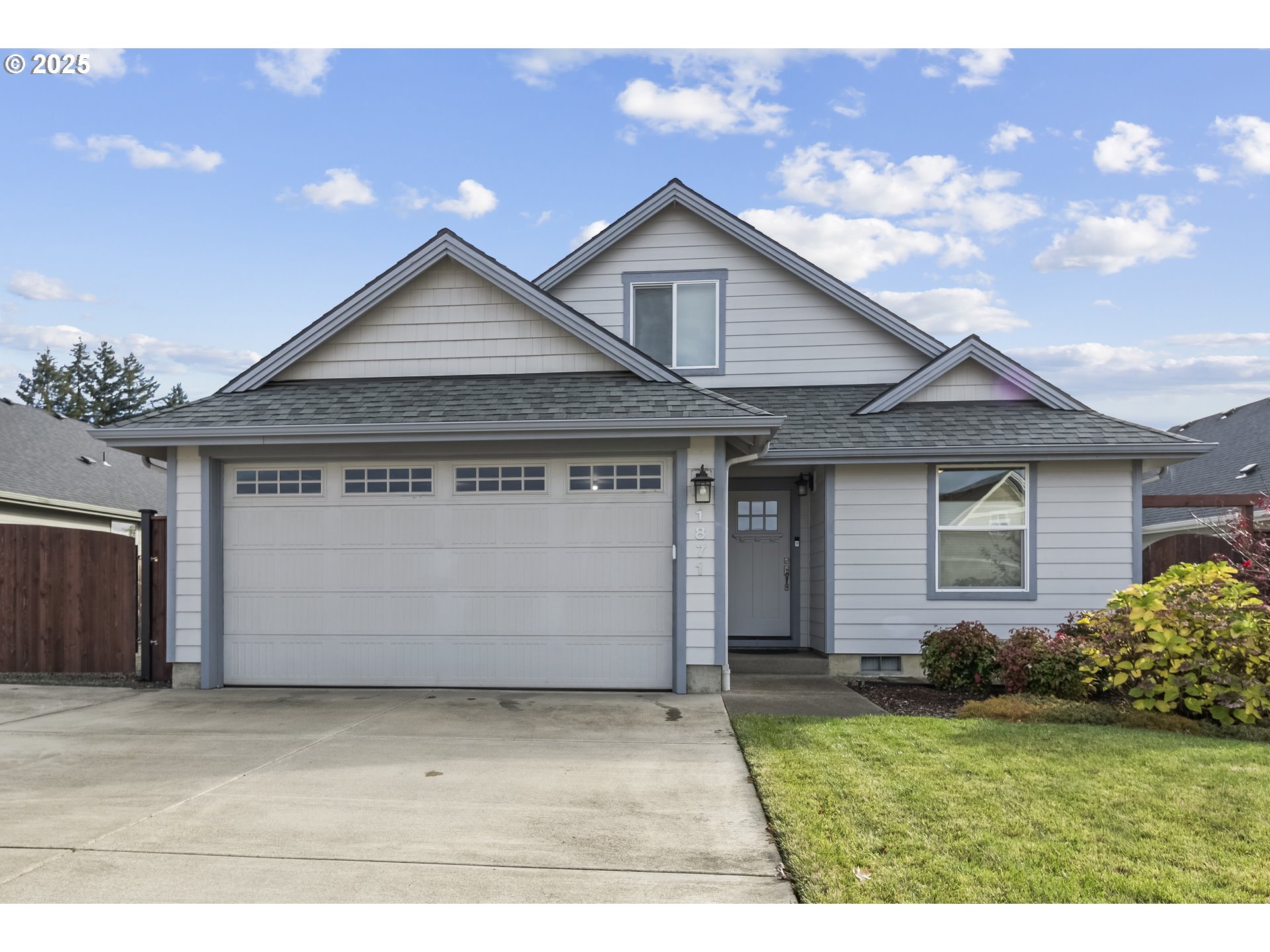 a front view of a house with a garden and yard