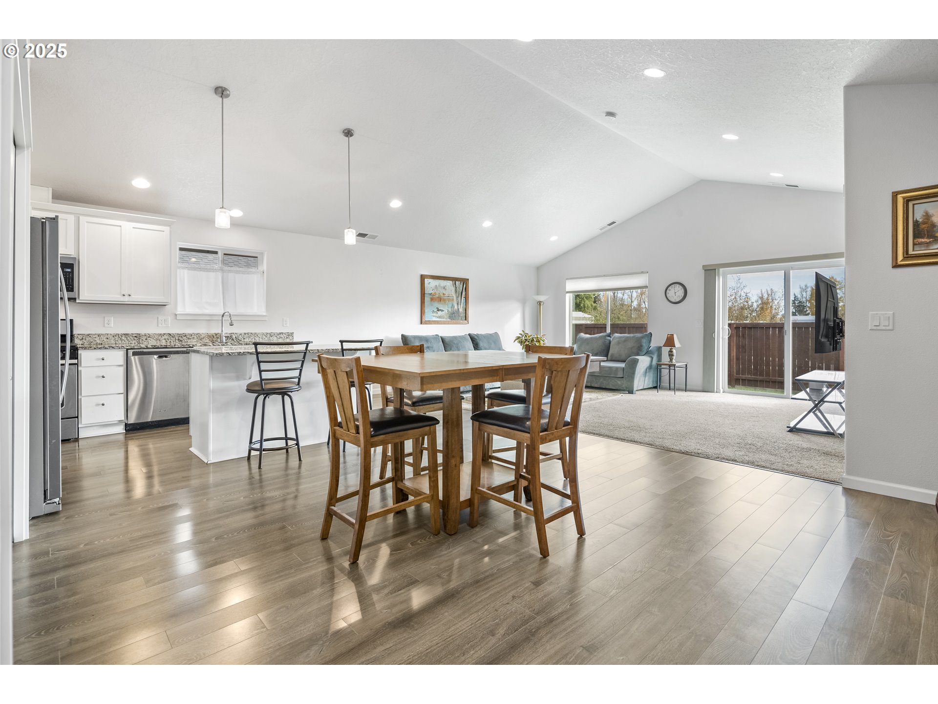 1871 Southeast Academy Street Dallas, OR 97338 - Photo 7 of 24 a open kitchen with stainless steel appliances granite countertop a dining table chairs and sink
