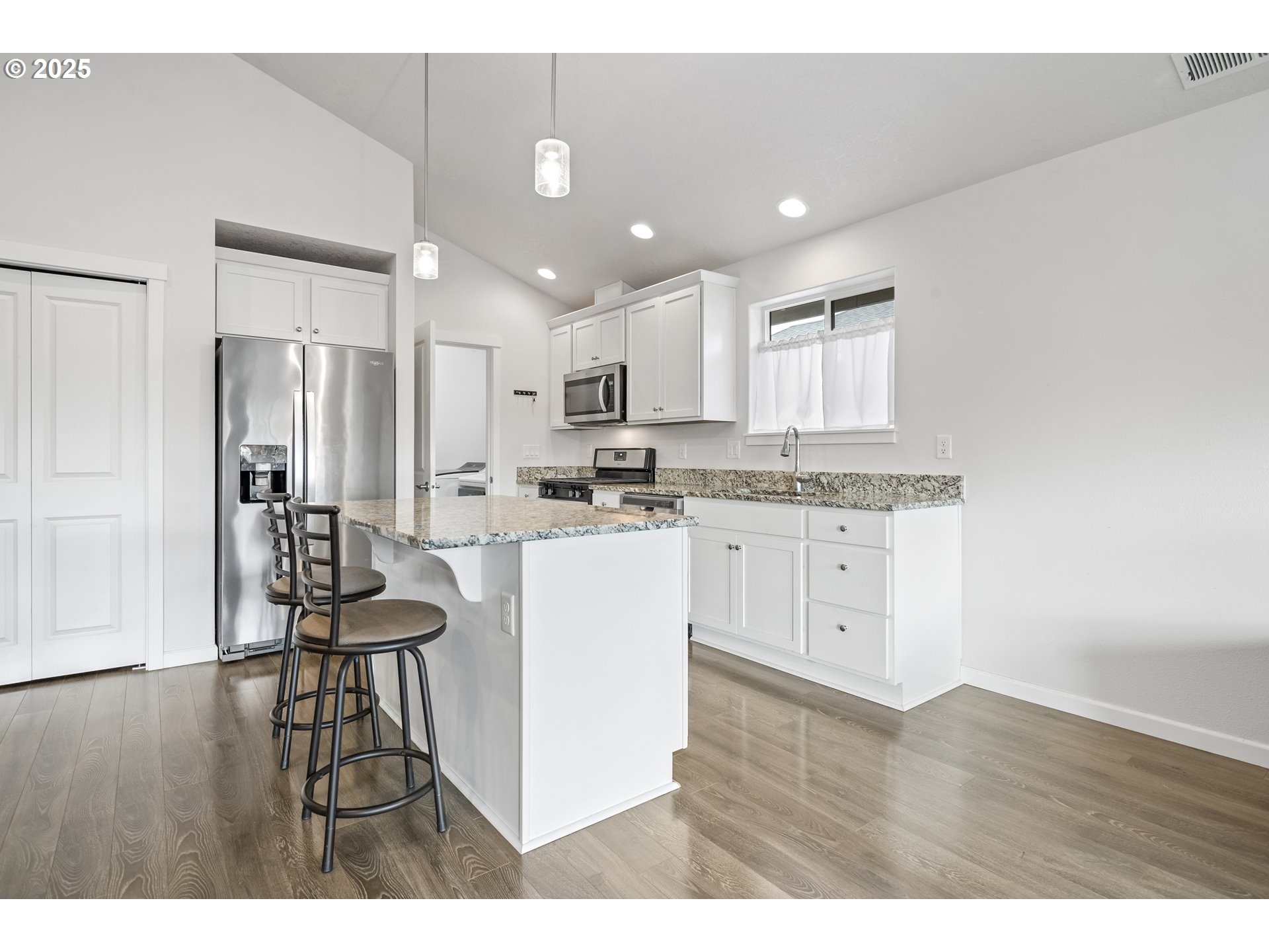 1871 Southeast Academy Street Dallas, OR 97338 - Photo 8 of 24 a kitchen with stainless steel appliances kitchen island granite countertop a refrigerator and a stove top oven