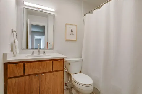 a bathroom with a sink a toilet and vanity