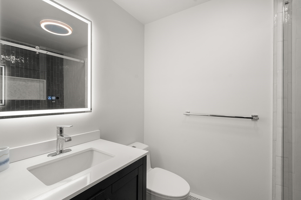 15 Adams Road Sudbury, MA 01776 - Photo 19 of 41 a bathroom with a sink vanity mirror and toilet