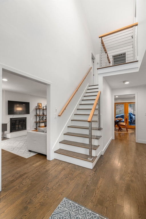 15 Adams Road Sudbury, MA 01776 - Photo 21 of 41 a view of a livingroom with wooden floor and stairs