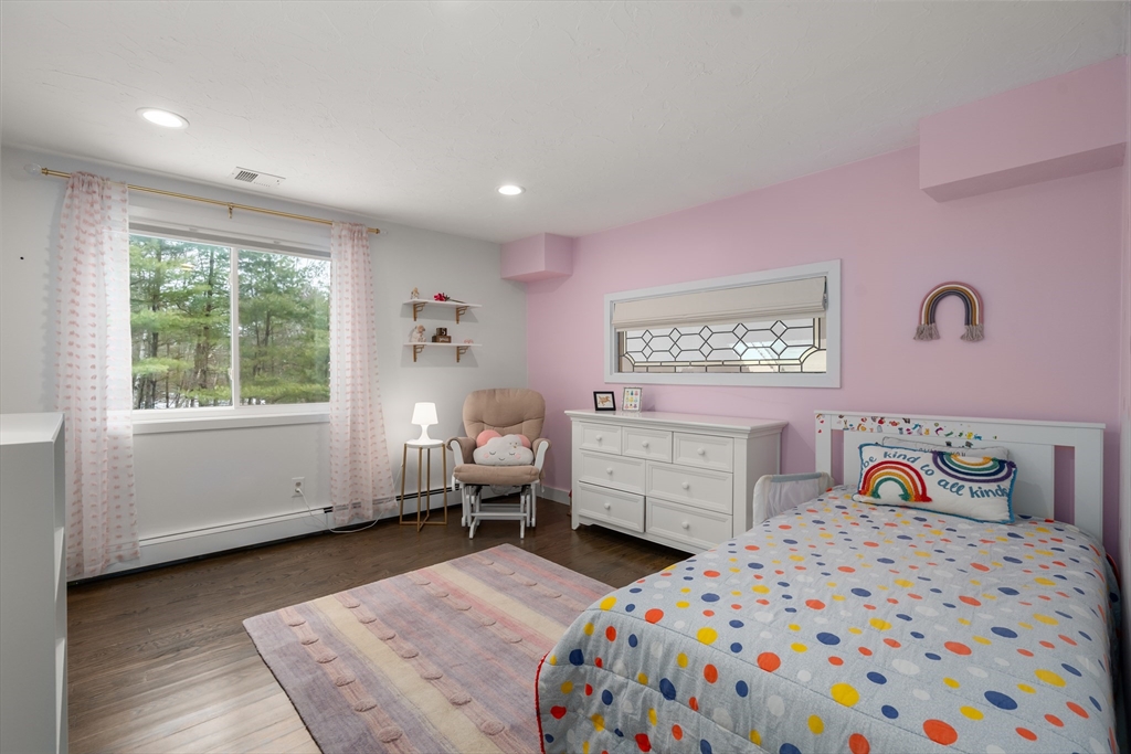 15 Adams Road Sudbury, MA 01776 - Photo 25 of 41 a bedroom with a bed and wooden floor