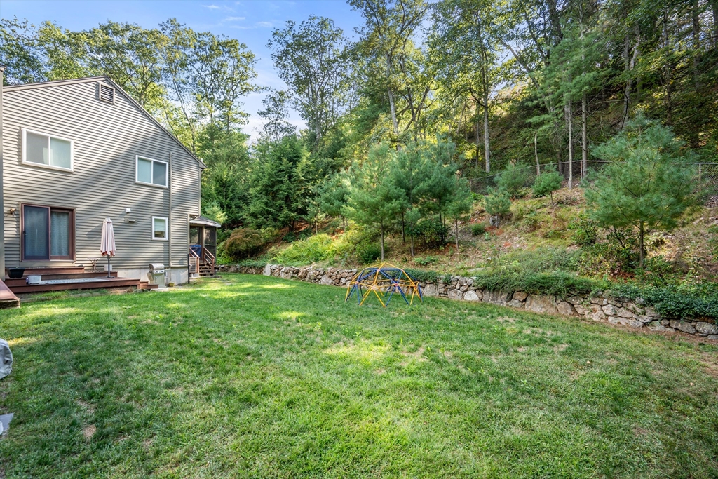 15 Adams Road Sudbury, MA 01776 - Photo 32 of 41 a backyard of a house with plants and large trees