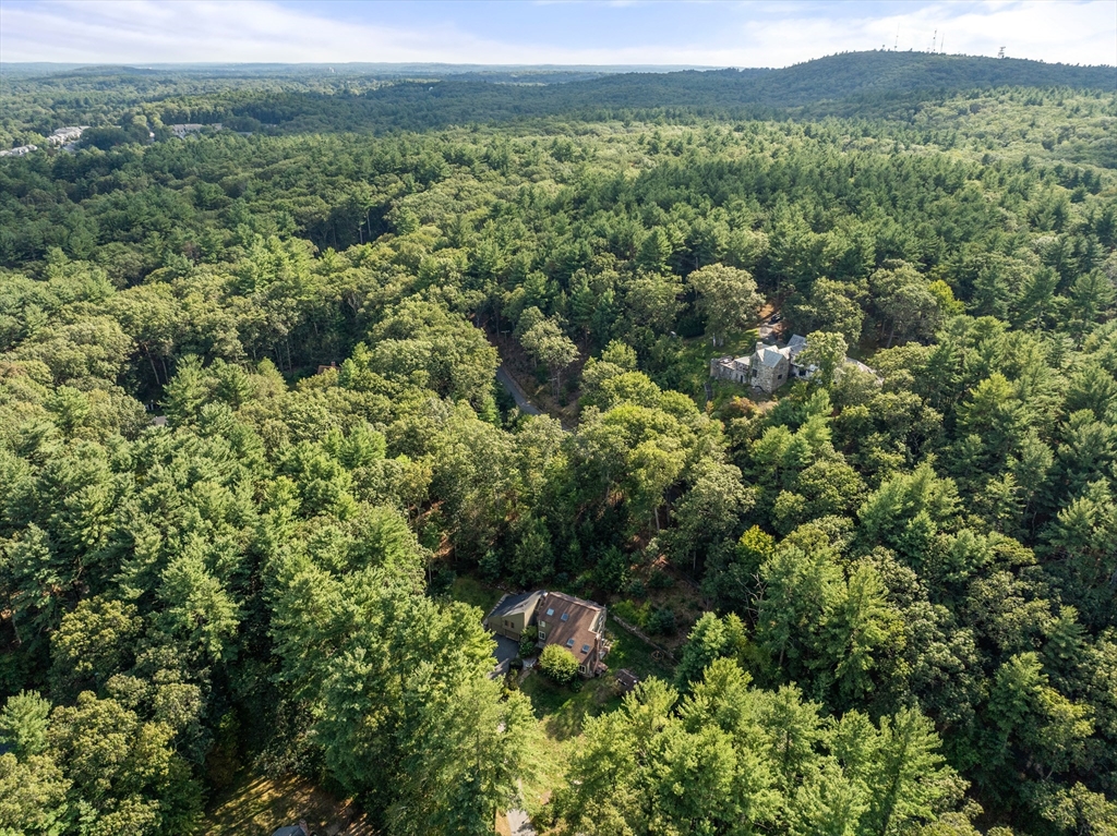 15 Adams Road Sudbury, MA 01776 - Photo 34 of 41 an aerial view of a houses with a lush green hillside