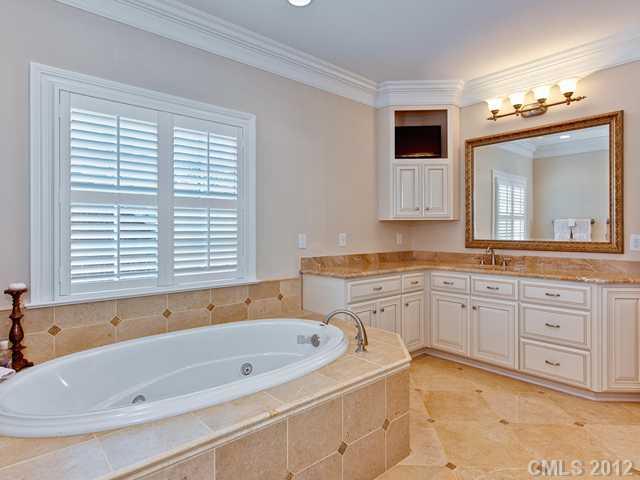 2228 Overhill Road Charlotte, NC 28211 - Photo 11 of 16 a bathroom with a tub a sink and a large mirror