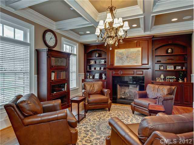 2228 Overhill Road Charlotte, NC 28211 - Photo 5 of 16 a living room with furniture a fireplace and a chandelier
