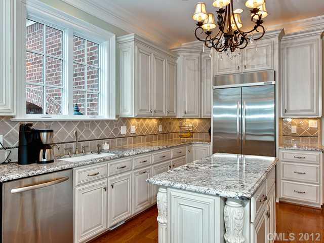 2228 Overhill Road Charlotte, NC 28211 - Photo 8 of 16 a kitchen with kitchen island granite countertop a sink a counter top space and cabinets