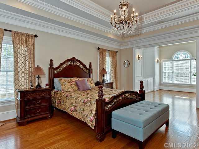 2228 Overhill Road Charlotte, NC 28211 - Photo 10 of 16 a spacious bedroom with a bed and a chandelier