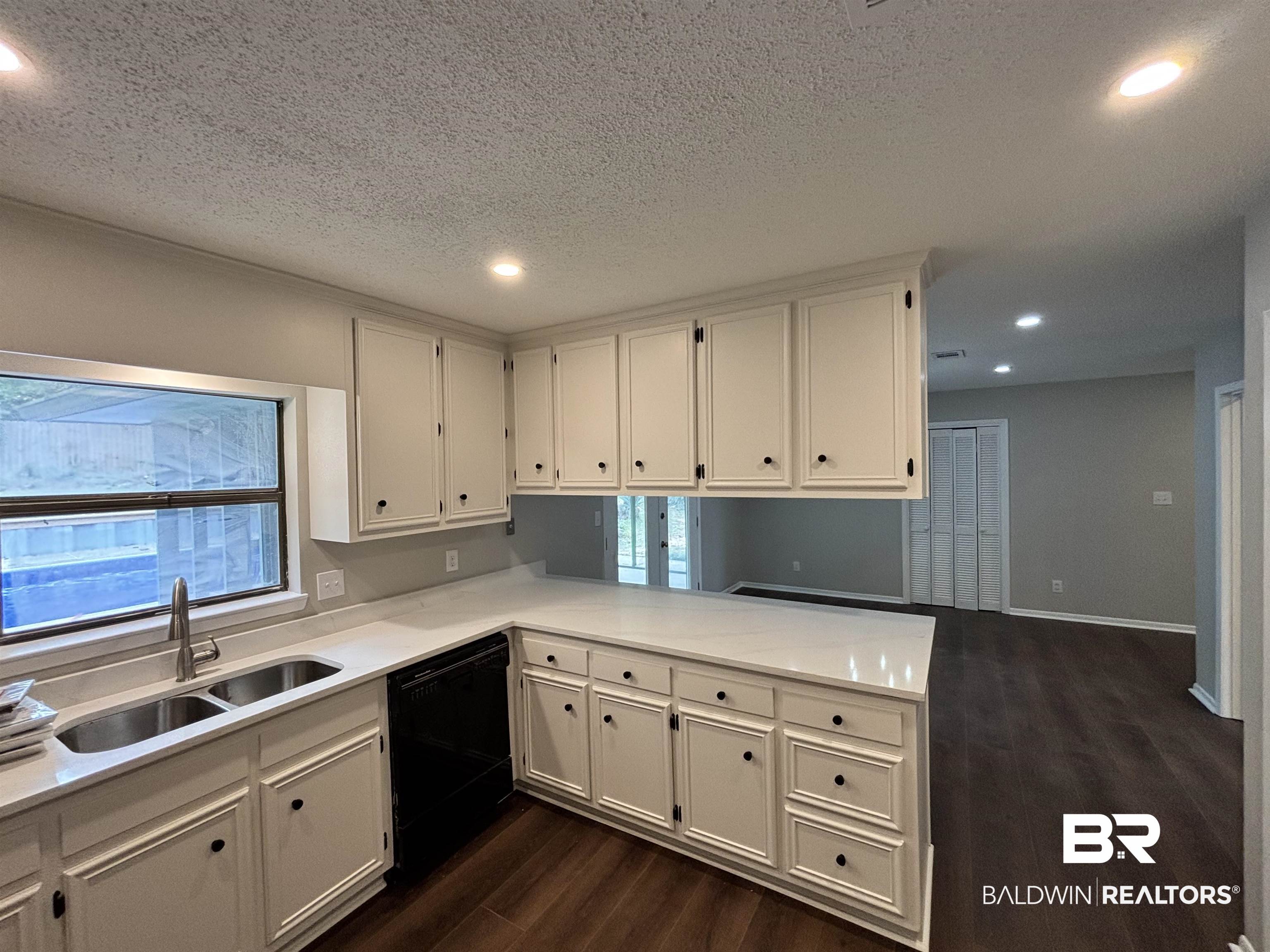 10 Soldiers Route Daphne, AL 36527 - Photo 9 of 26 Kitchen with dark wood finished floors, recessed lighting, black dishwasher, a peninsula, and white cabinetry