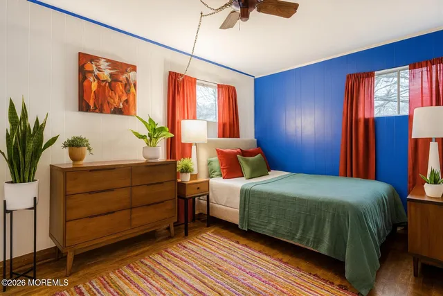 a bedroom with a large bed and a potted plant