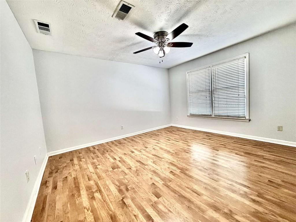 4129 Boxwood Way Duluth, GA 30096 - Photo 15 of 27 an empty room with wooden floor and windows