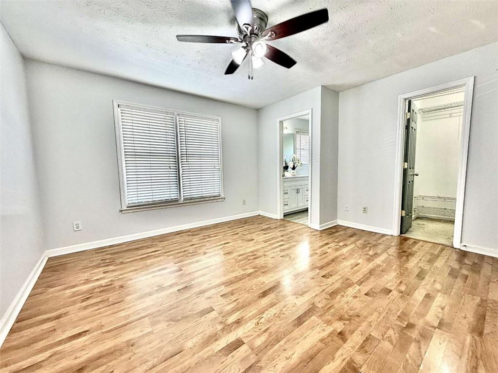 4129 Boxwood Way Duluth, GA 30096 - Photo 16 of 27 a view of an empty room with a window and a kitchen