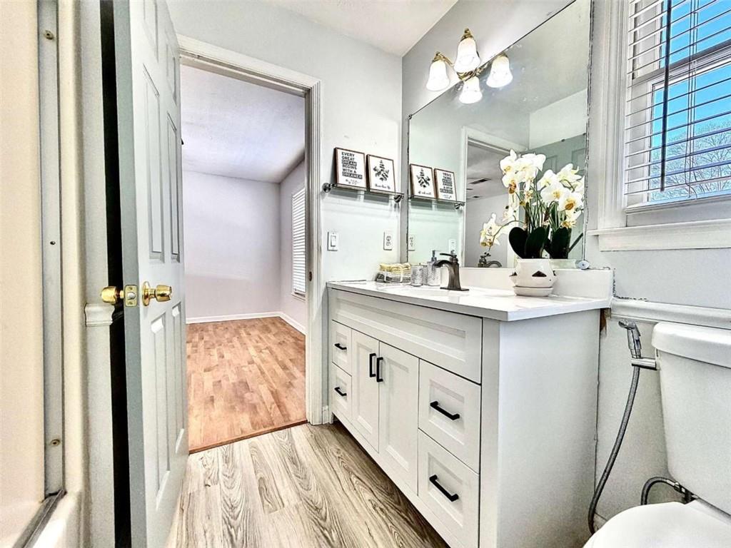 4129 Boxwood Way Duluth, GA 30096 - Photo 19 of 27 a bathroom with a sink vanity mirror and toilet