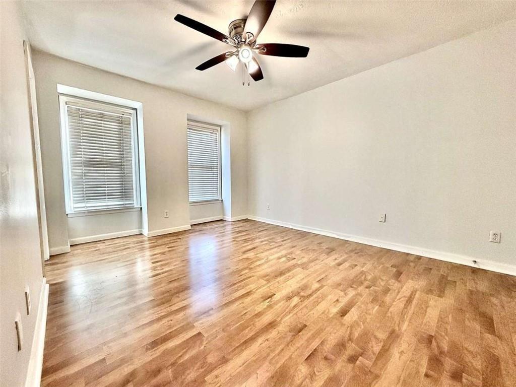 4129 Boxwood Way Duluth, GA 30096 - Photo 20 of 27 an empty room with wooden floor and windows