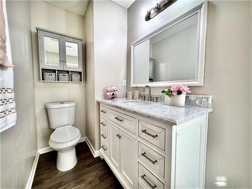 4129 Boxwood Way Duluth, GA 30096 - Photo 23 of 27 a bathroom with a granite countertop toilet sink and a mirror