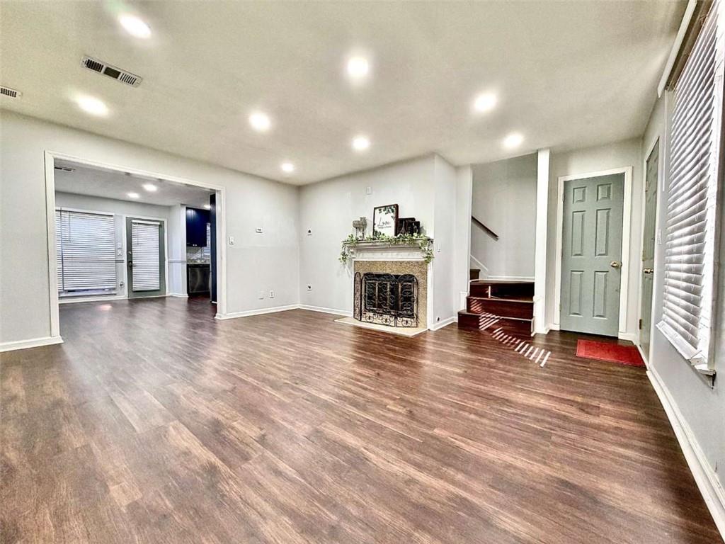 4129 Boxwood Way Duluth, GA 30096 - Photo 3 of 27 an empty room with wooden floor fireplace and windows