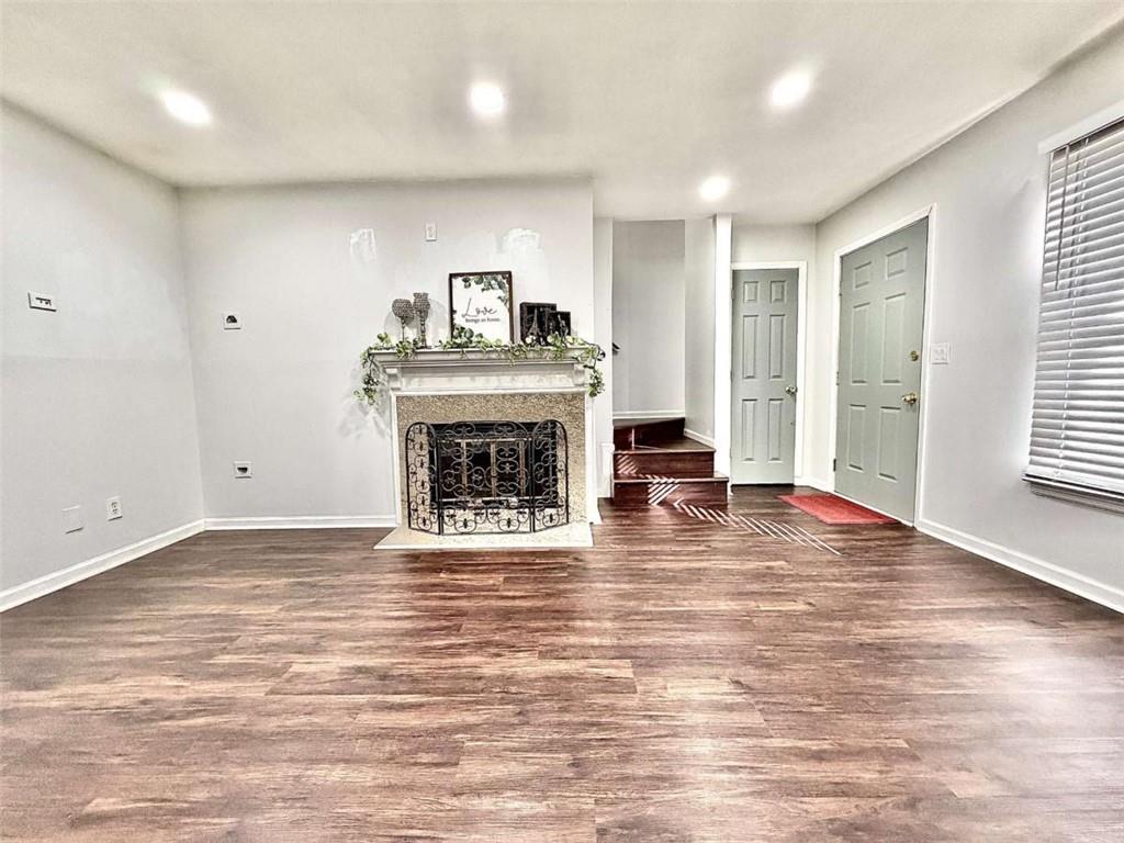 4129 Boxwood Way Duluth, GA 30096 - Photo 4 of 27 a view of empty room with wooden floor and fireplace