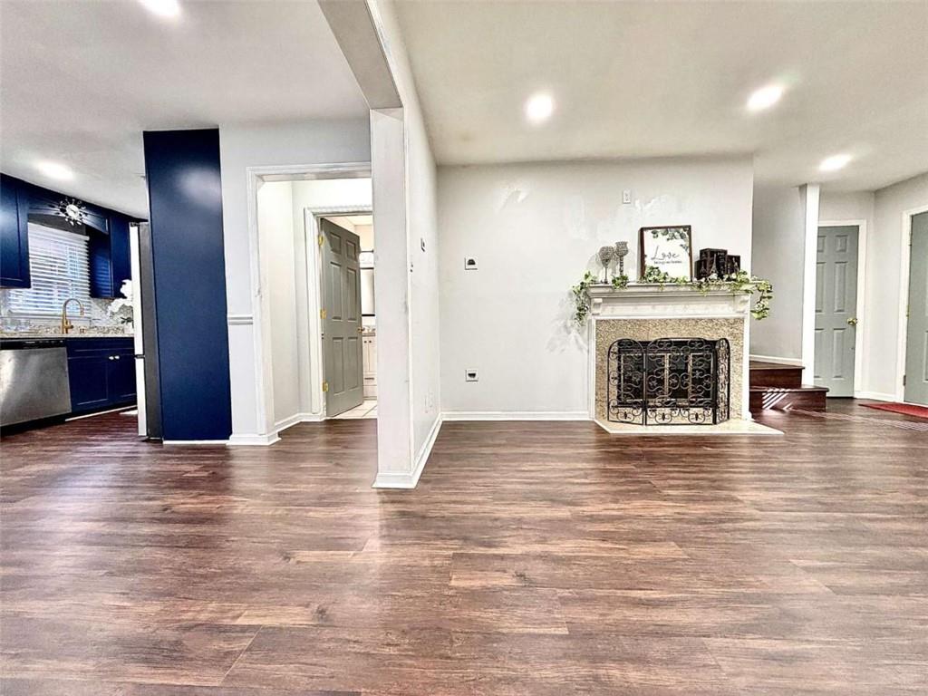 4129 Boxwood Way Duluth, GA 30096 - Photo 6 of 27 an empty room with wooden floor and a fireplace