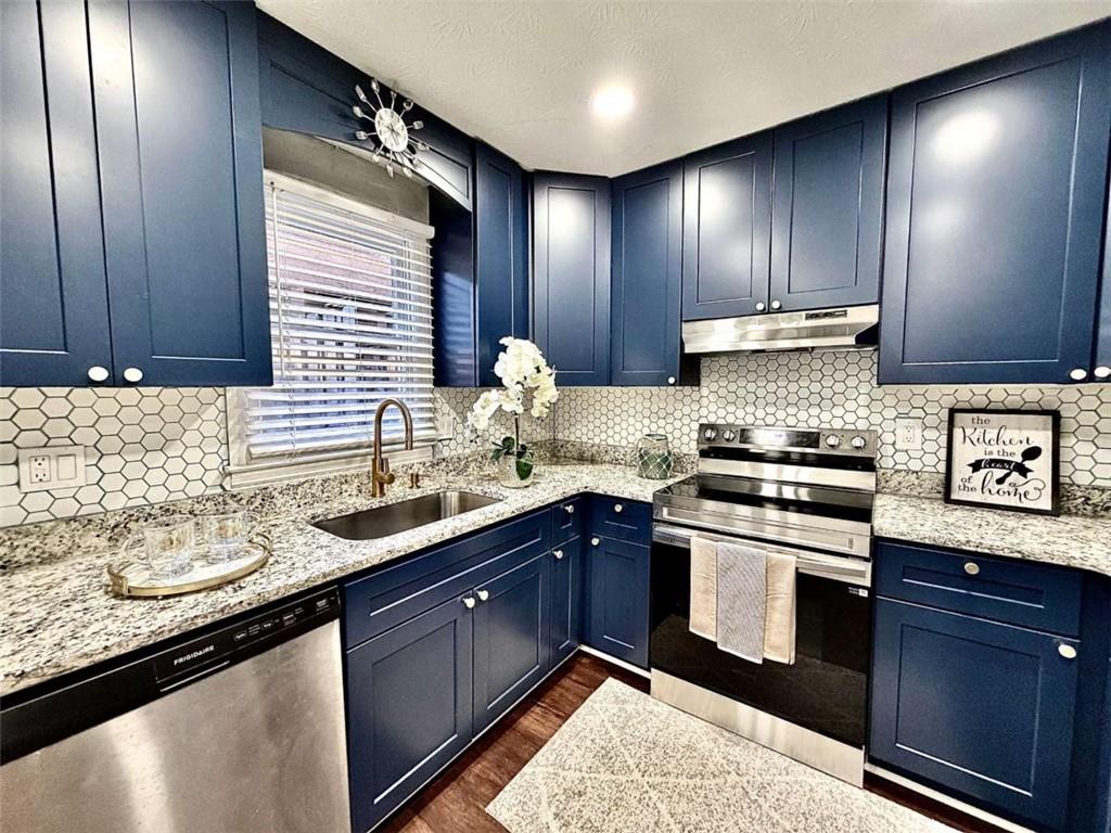 4129 Boxwood Way Duluth, GA 30096 - Photo 8 of 27 a kitchen with stainless steel appliances granite countertop wooden cabinets and a sink