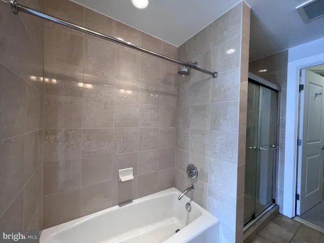 a bathroom with a bathtub and a shower