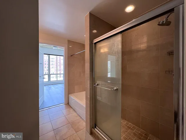 a bathroom with a glass shower door