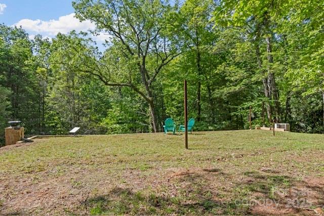 167 Simmons Ridge Road Spruce Pine, NC 28777 - Photo 23 of 44 a backyard of a house with lots of green space