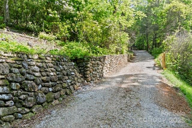 167 Simmons Ridge Road Spruce Pine, NC 28777 - Photo 26 of 44 a view of a yard with plants and large trees