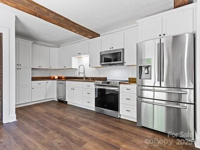 a kitchen with stainless steel appliances cabinets a microwave and a refrigerator