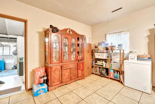 a view of a kitchen with furniture and an empty room