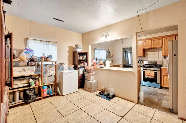 a kitchen with refrigerator and cabinets