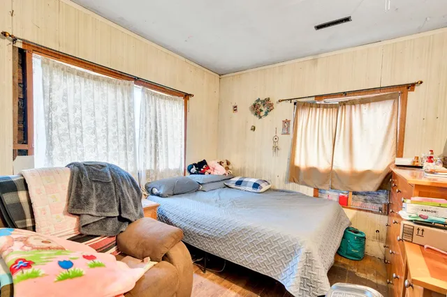 a bedroom with furniture and a window