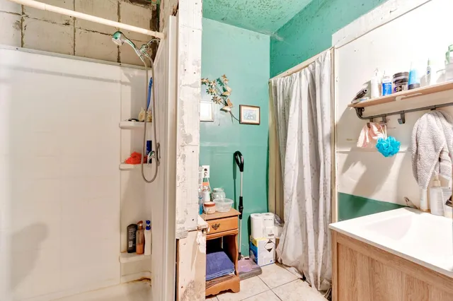 a bathroom with a shower curtain and a window