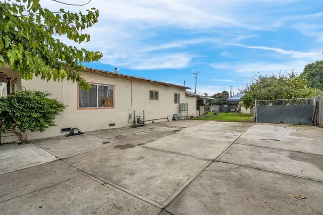 a backyard of a house with plants and trees