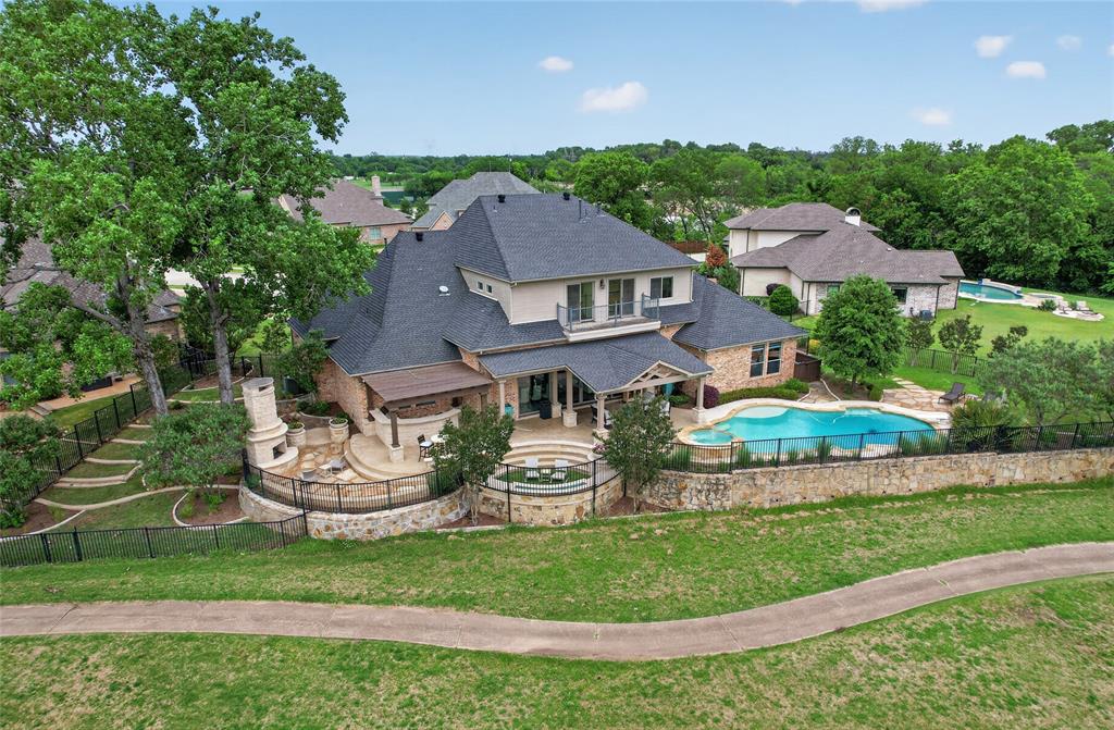 Experience the ultimate in luxury living with this custom Trinity Shores estate nestled on a premier third-acre cul-de-sac lot overlooking Riverchase Golf Course. 