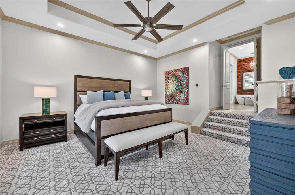 139 Trinity Court Coppell, TX 75019 - Photo 16 of 40 The remodeled primary suite offers a custom freestanding tub, semi-frameless shower, dual-sink granite vanities, and a massive walk-in closet with built-in dressers and a large safe.