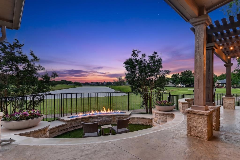 139 Trinity Court Coppell, TX 75019 - Photo 3 of 40 The backyard is a private oasis featuring a pool and spa with a waterfall, an outdoor kitchen with a pergola and bar area, an outdoor fireplace, and a stunning sunken seating area with a contemporary linear firewall.