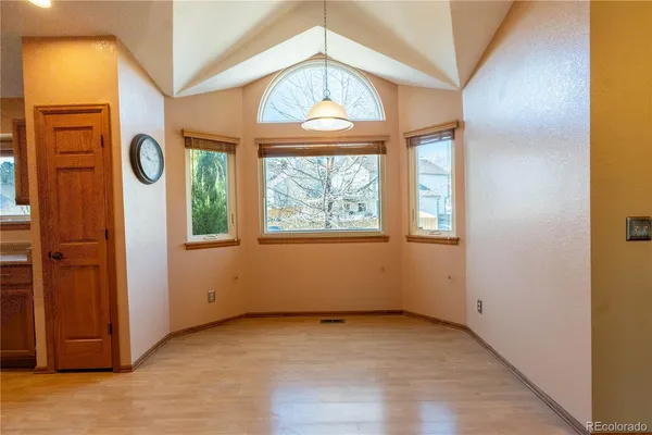 an empty room with a window and a mirror