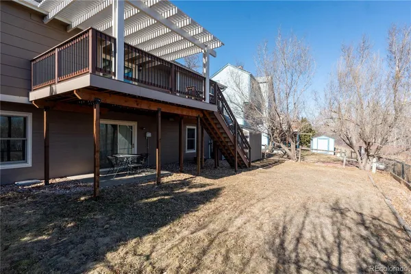 a backyard of a house with table and chairs