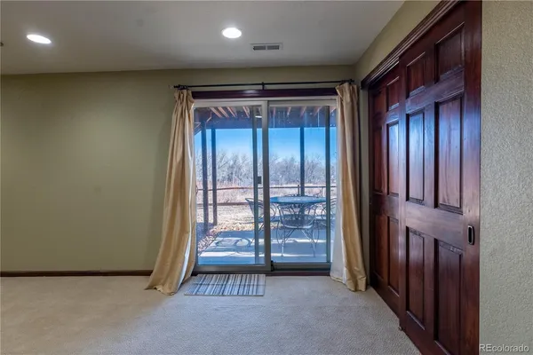 an empty room with furniture and window